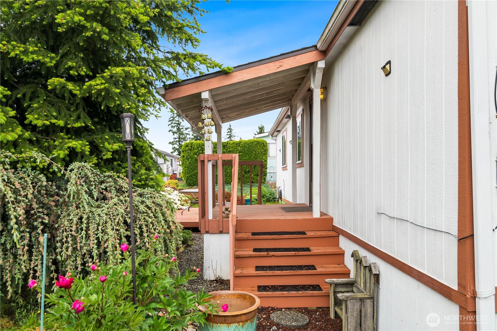 1427 100th Street Southwest, Unit 145 Everett, WA 98204 - Photo 2 of 36 a view of a patio with table and chairs and potted plants