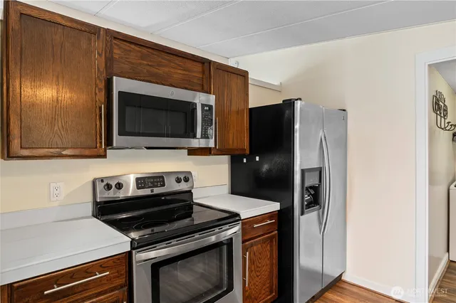 a kitchen with a refrigerator stove and microwave