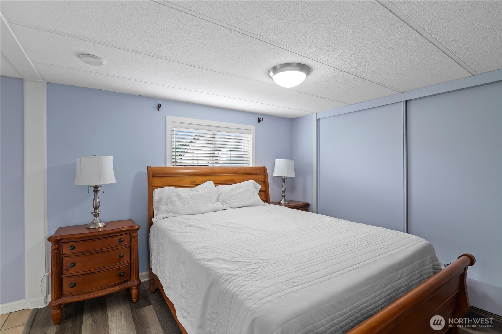 1427 100th Street Southwest, Unit 145 Everett, WA 98204 - Photo 27 of 36 a bedroom with a bed and lamp