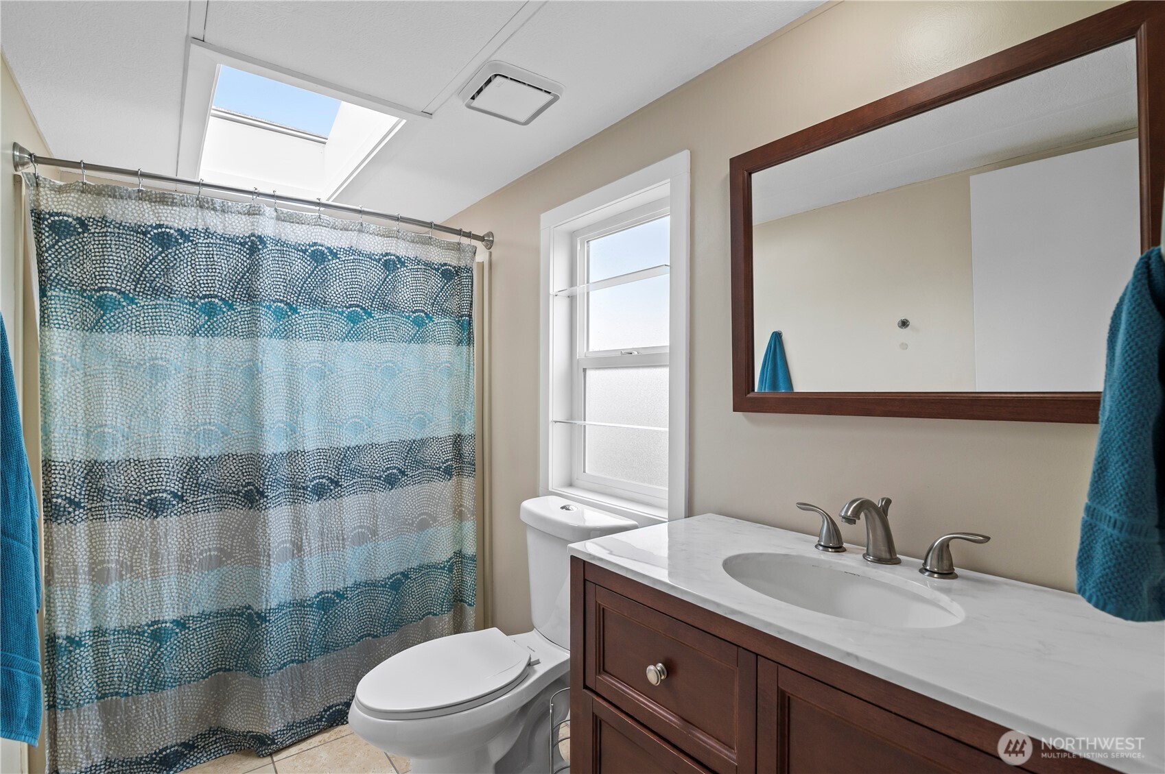 1427 100th Street Southwest, Unit 145 Everett, WA 98204 - Photo 28 of 36 a bathroom with a granite countertop sink a toilet a mirror and shower