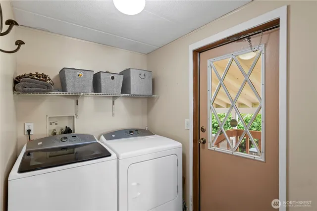 a view of storage and utility room with washer and dryer
