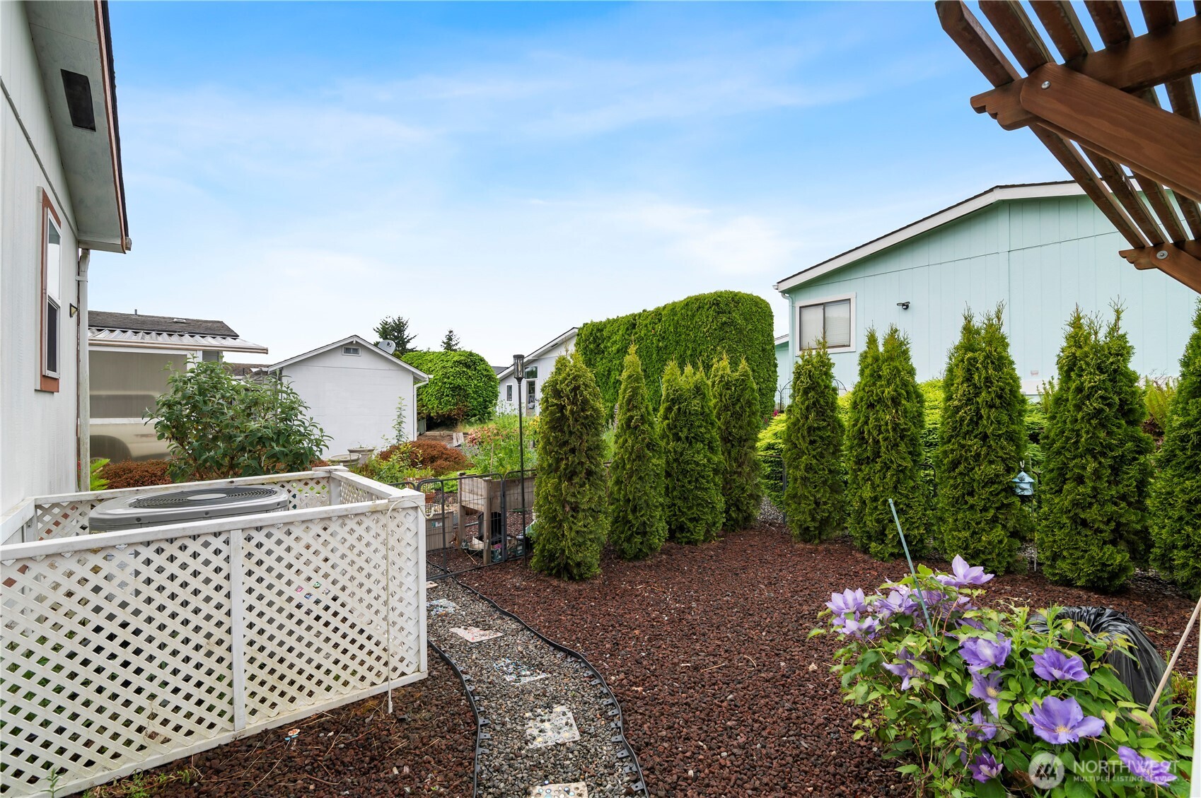 1427 100th Street Southwest, Unit 145 Everett, WA 98204 - Photo 34 of 36 a view of a house with a flower garden