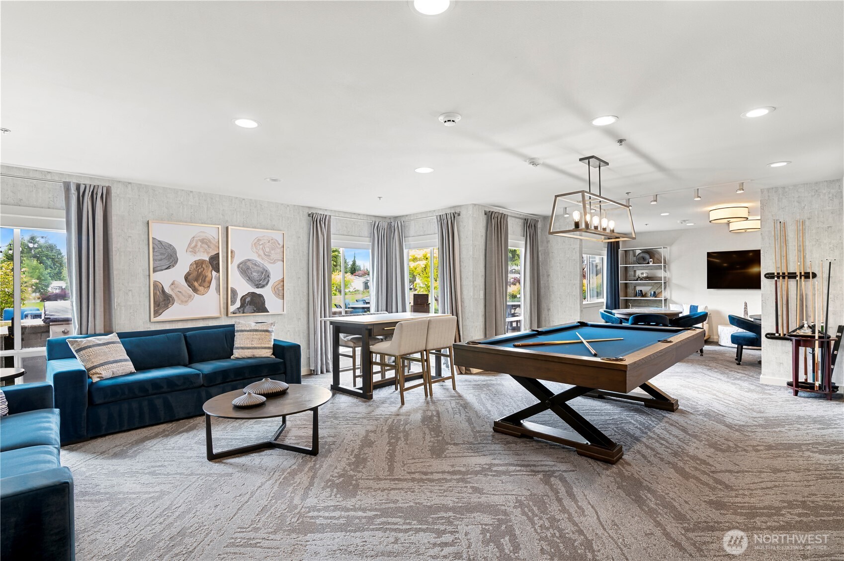1427 100th Street Southwest, Unit 145 Everett, WA 98204 - Photo 9 of 36 a living room with furniture a table and large flat screen tv