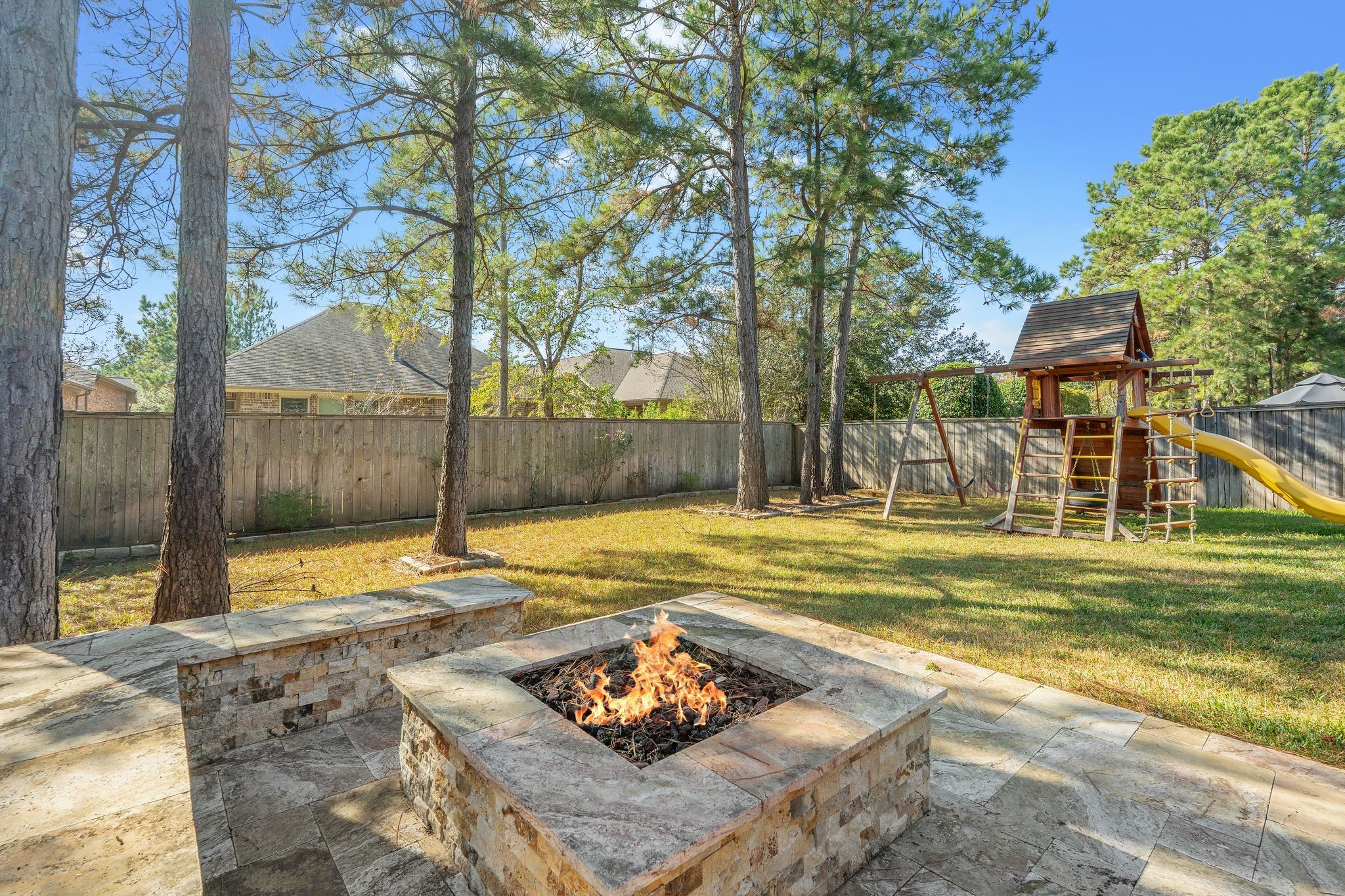 166 Lindenberry Circle Tomball, TX 77375 - Photo 36 of 43 Everyone will enjoy this backyard with a custom bench and firepit!
