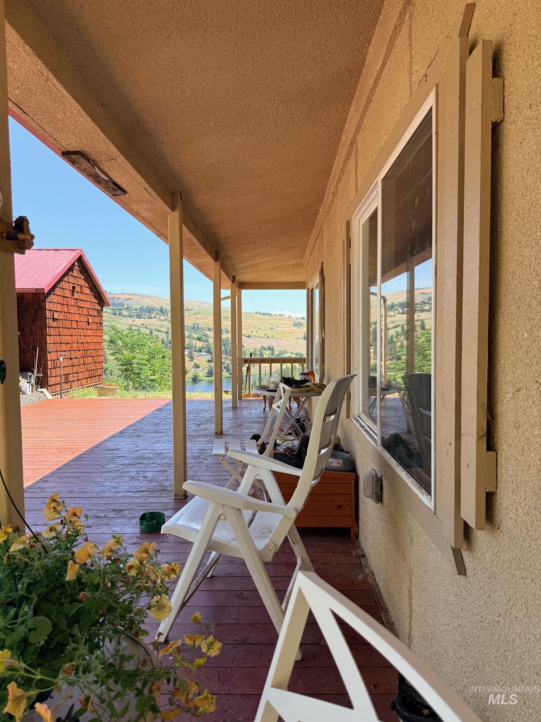 35322 River Road Lenore, ID 83541 - Photo 34 of 42 Expansive covered porch featuring a textured ceiling, durable wood-finish decking, and multiple windows