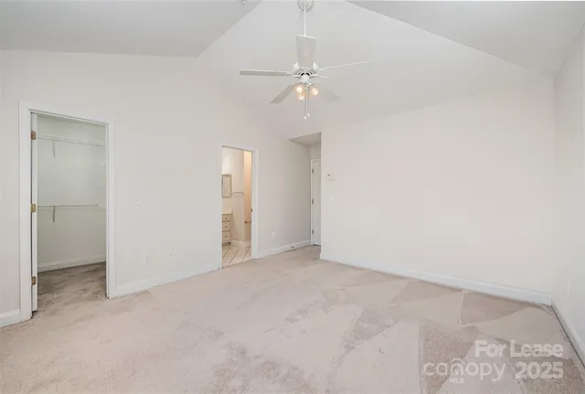 an empty room with fan and entrance