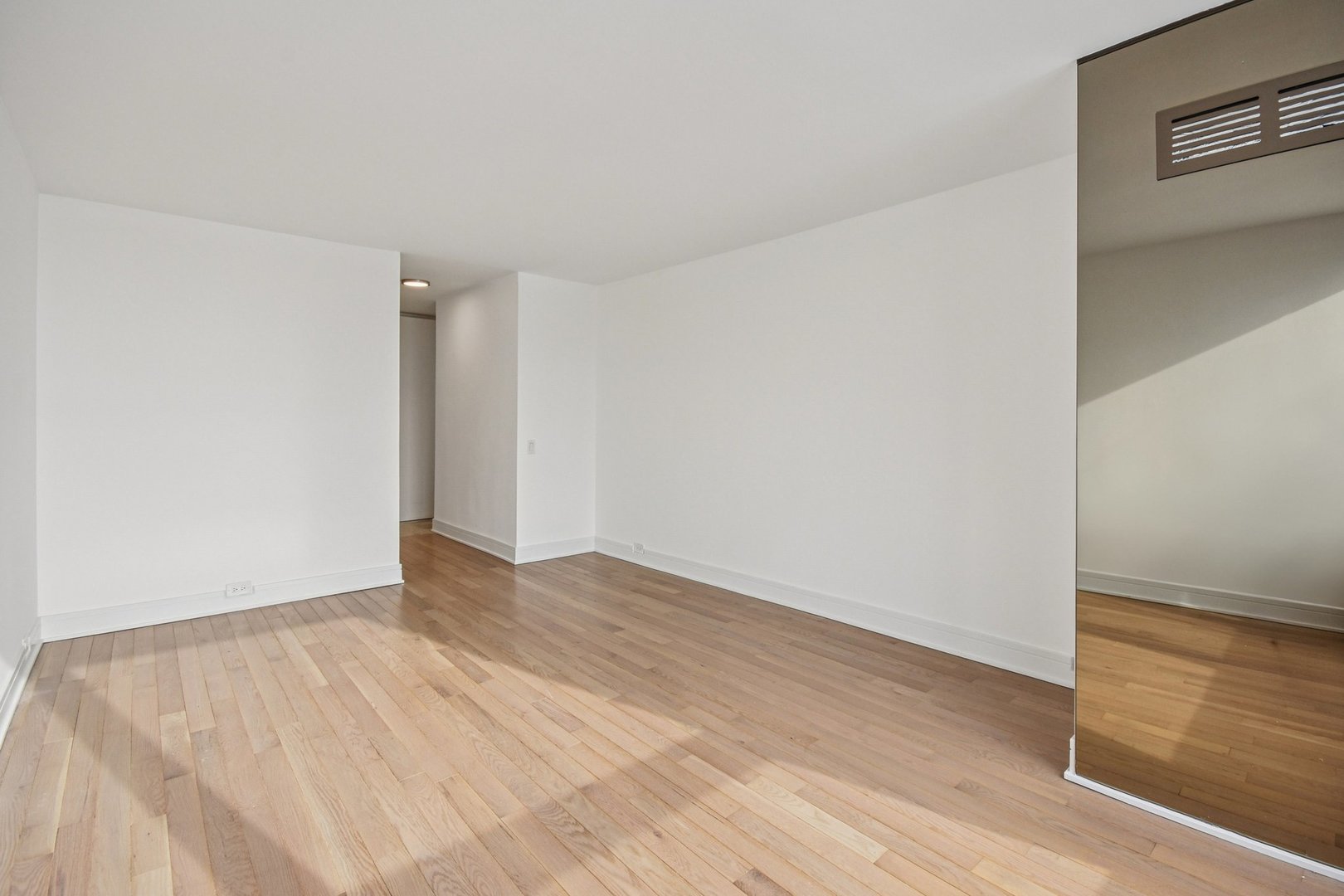 360 East Randolph Street, Unit 1102 Chicago, IL 60601 - Photo 13 of 27 a view of an empty room with wooden floor