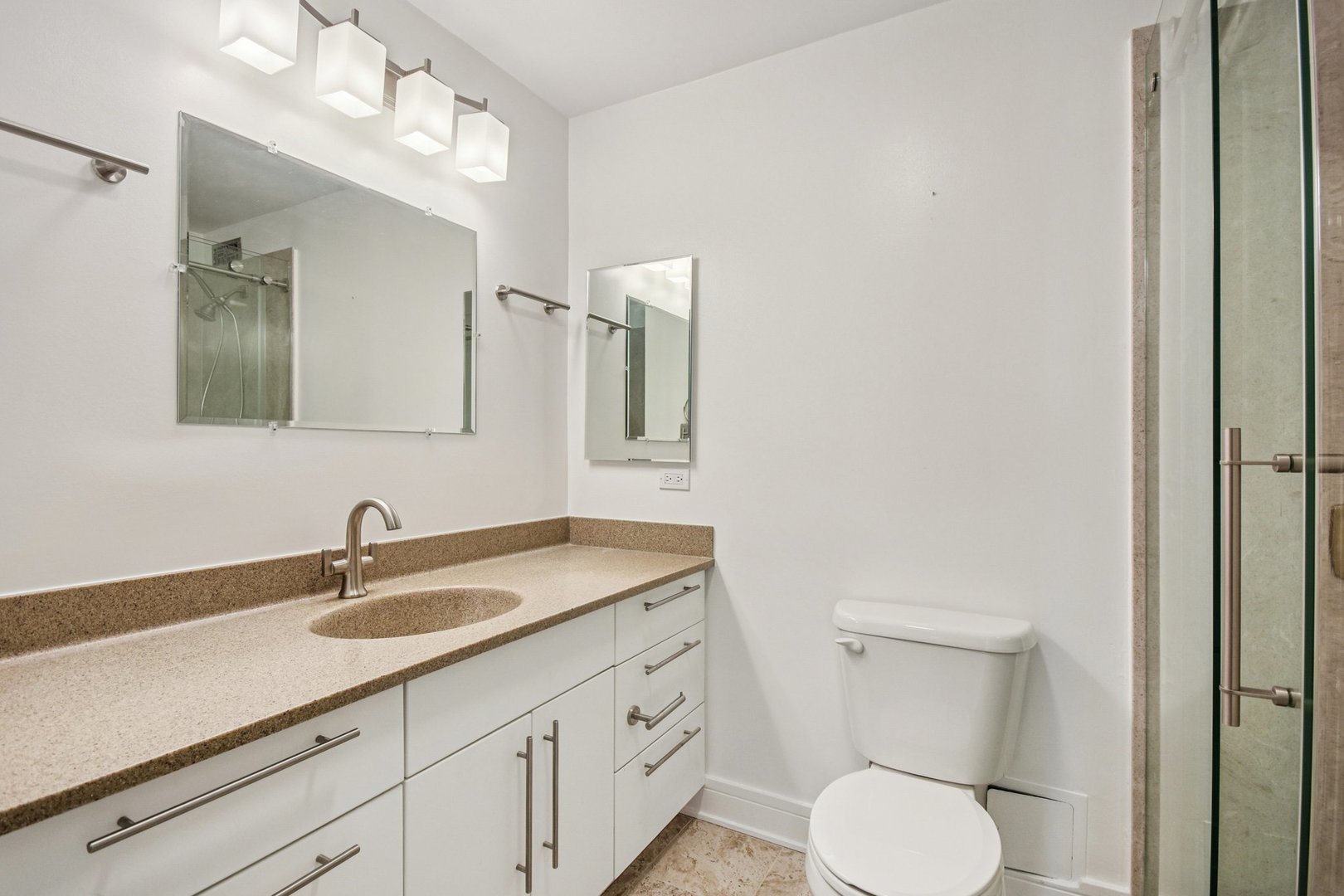 360 East Randolph Street, Unit 1102 Chicago, IL 60601 - Photo 14 of 27 a bathroom with a toilet sink and mirror
