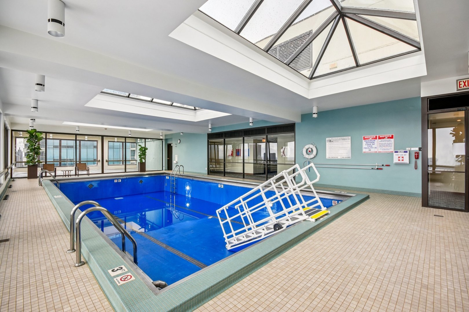 360 East Randolph Street, Unit 1102 Chicago, IL 60601 - Photo 22 of 27 a bed room with a bed and glass door