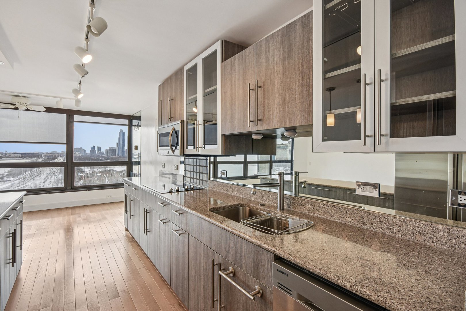 360 East Randolph Street, Unit 1102 Chicago, IL 60601 - Photo 8 of 27 a kitchen with stainless steel appliances granite countertop a sink a stove and cabinets