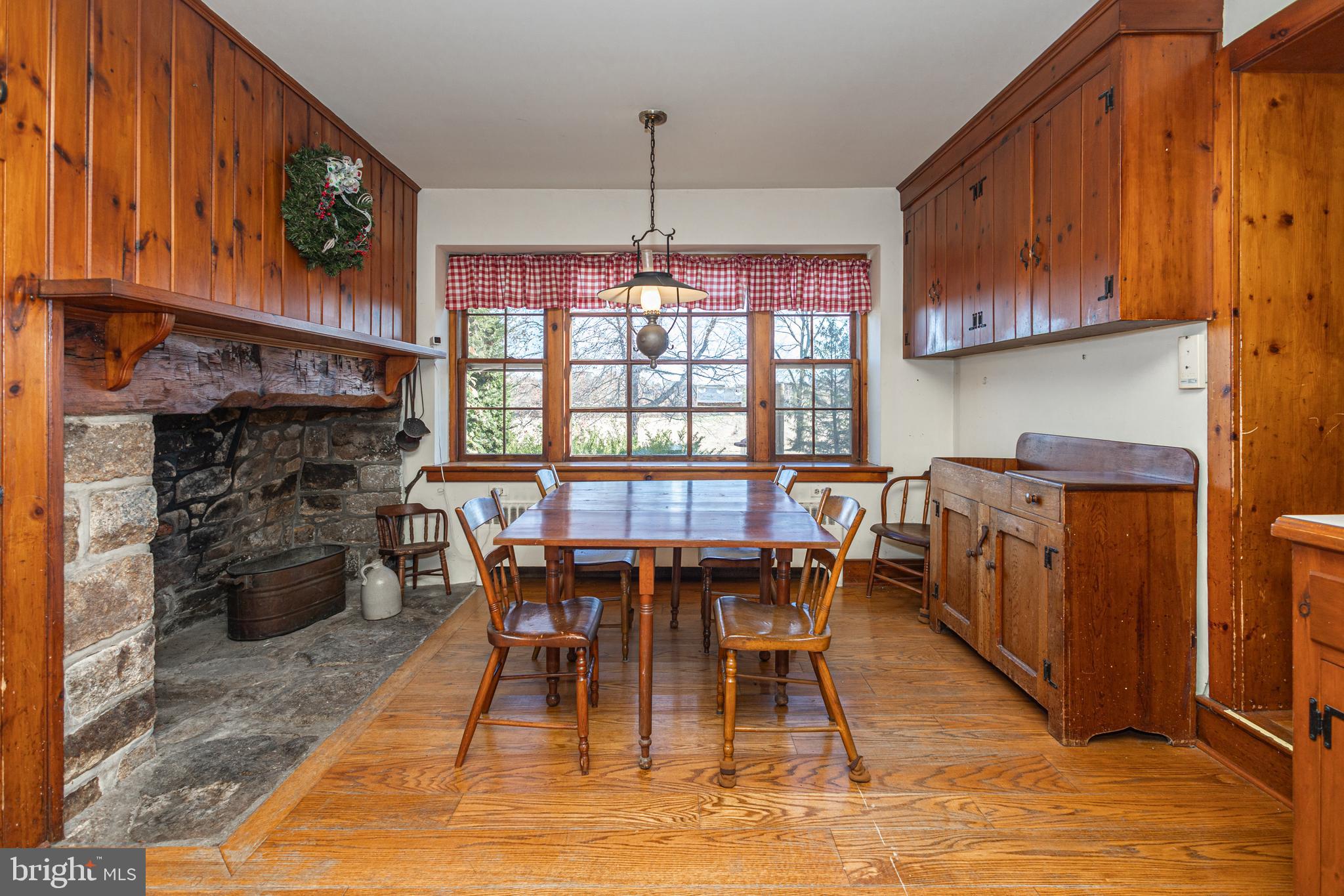 2209 Swamp Road Furlong, PA 18925 - Photo 14 of 59 a dining room with furniture a fireplace and wooden floor