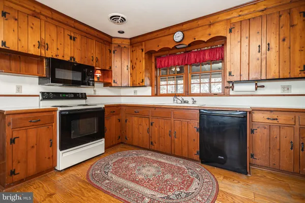 a bedroom with a large bed and wooden floor