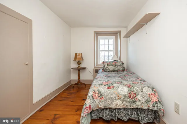 a bathroom with a granite countertop toilet sink and mirror