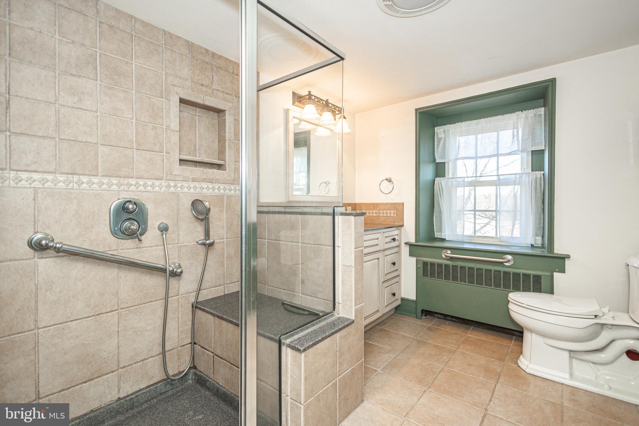 2209 Swamp Road Furlong, PA 18925 - Photo 24 of 59 a bathroom with a granite countertop toilet sink and mirror