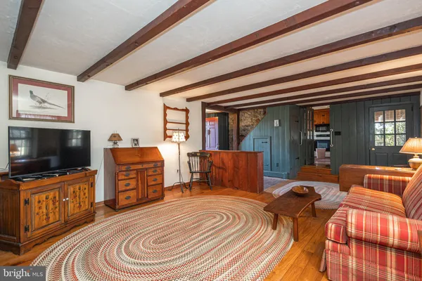 a bedroom with a bed and flat tv screen on the dresser