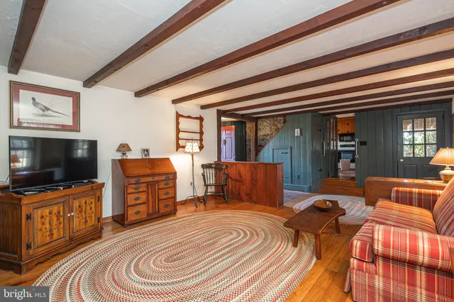 a bedroom with a bed and flat tv screen on the dresser