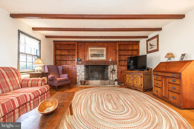 a bedroom with a bed chair and a window