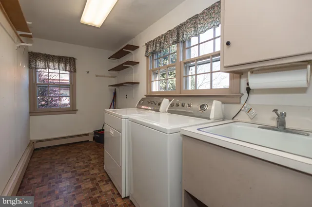 a bathroom with a sink a toilet and a window