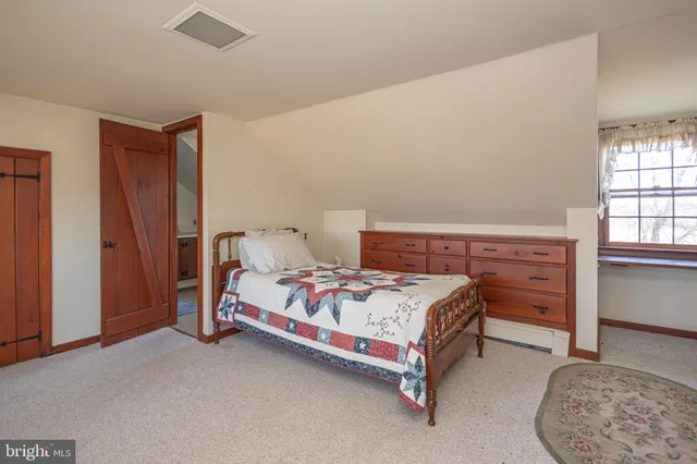 a view of a house with a big yard and large trees