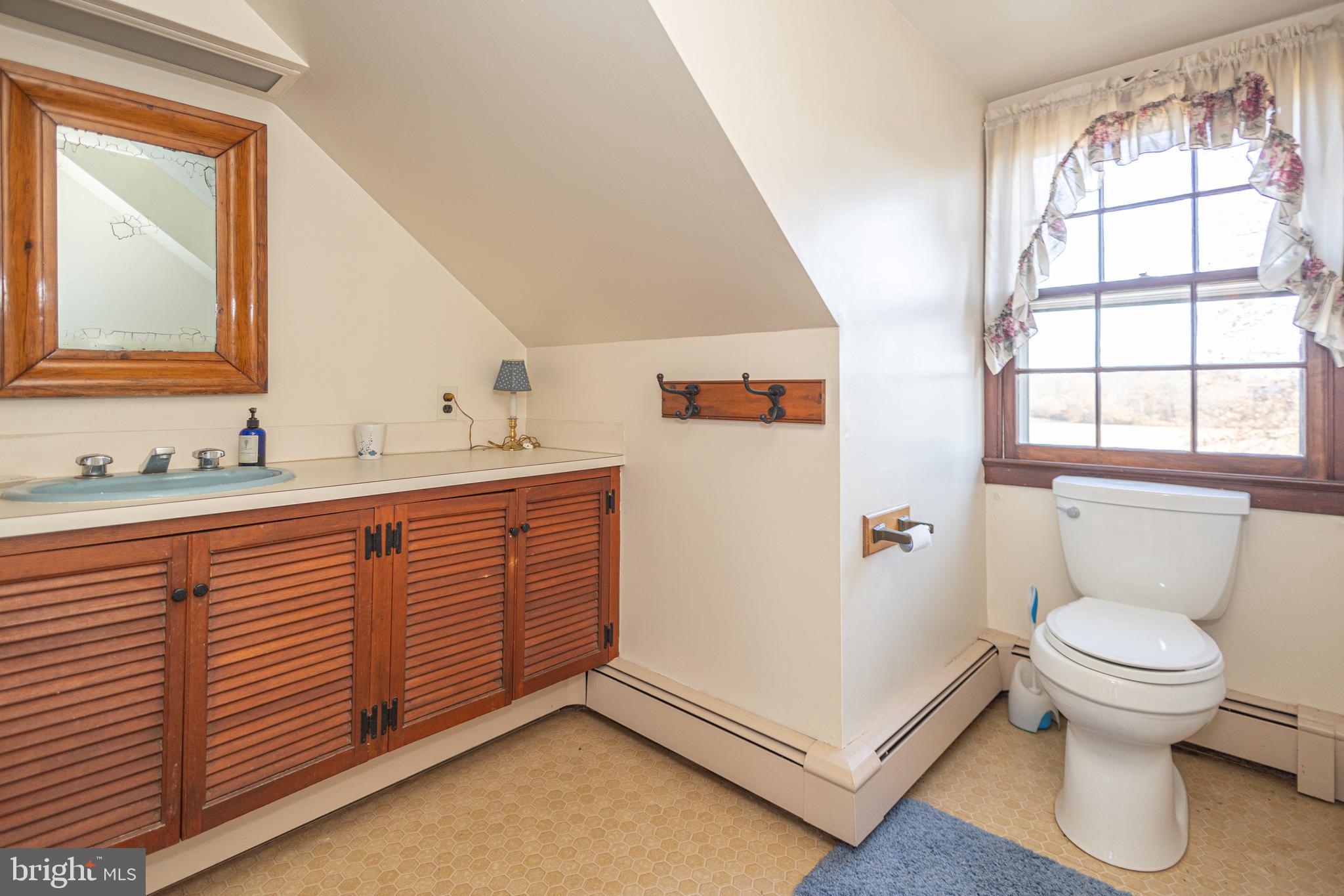 2209 Swamp Road Furlong, PA 18925 - Photo 40 of 59 a bathroom with a sink a toilet and a window