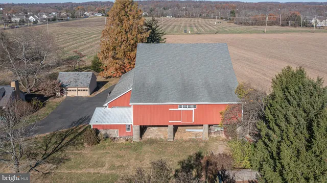 an aerial view of a house with a yard and lake view