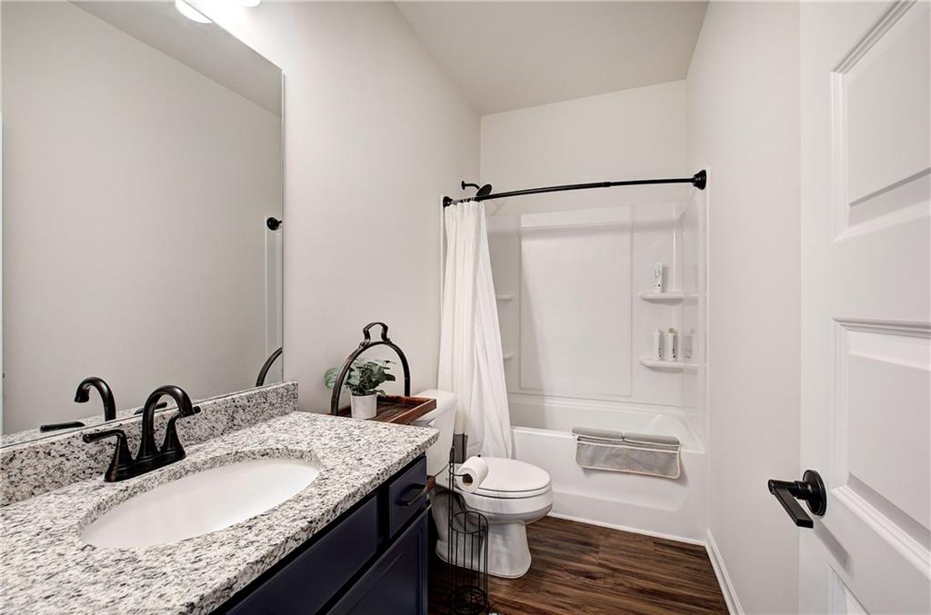 402 Perth Drive Cartersville, GA 30121 - Photo 25 of 31 a bathroom with a granite countertop sink toilet and shower
