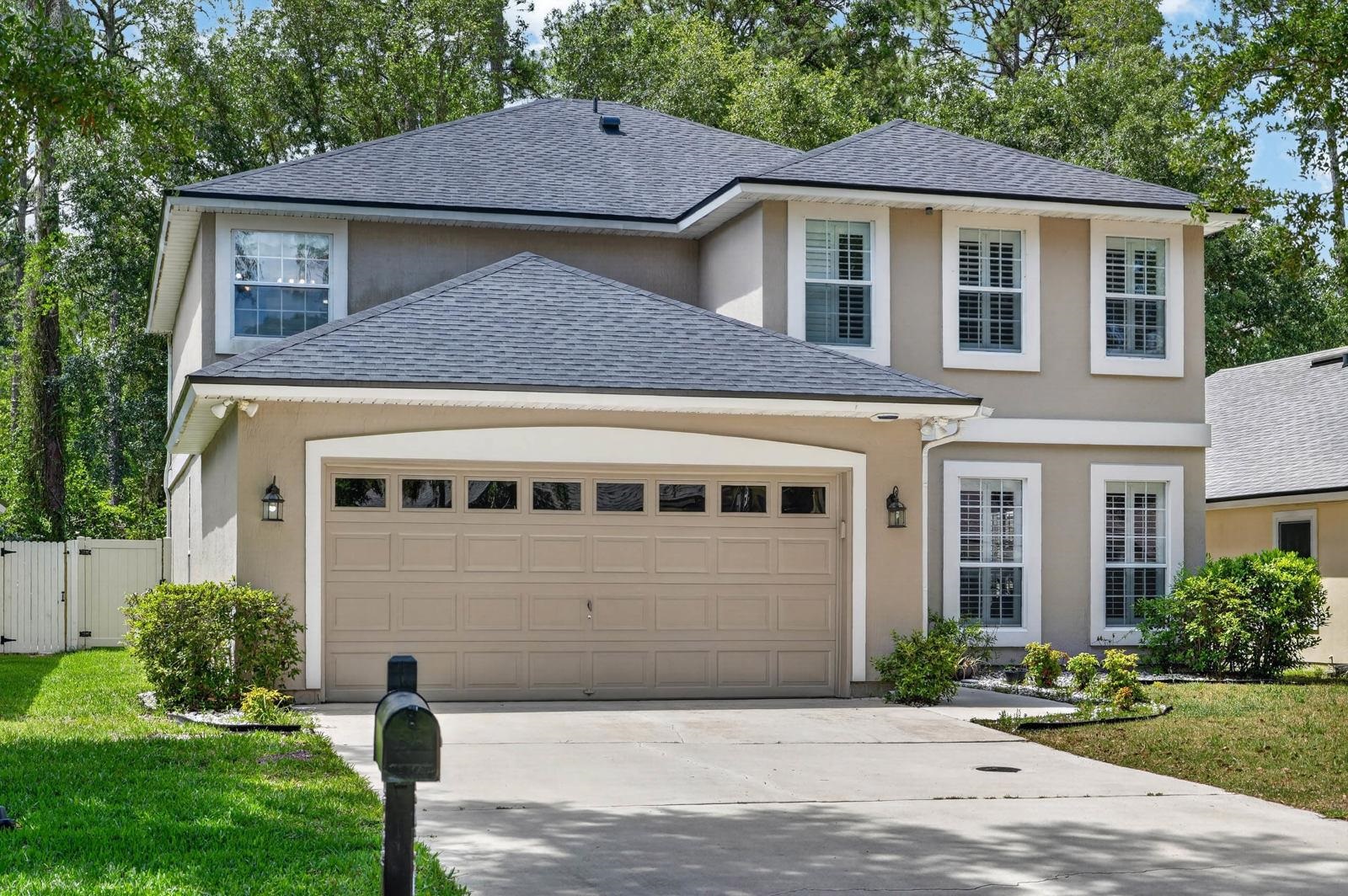 a front view of a house with a yard and garage