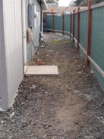 a view of a backyard with wooden fence