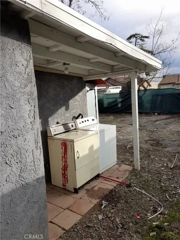 a view of a patio with table and chairs