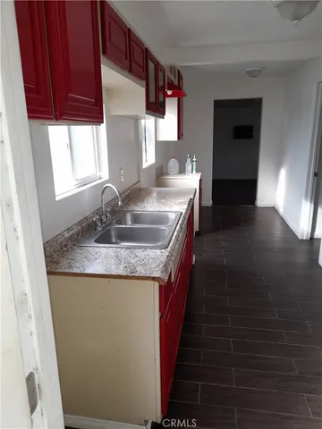 a kitchen with sink and cabinets