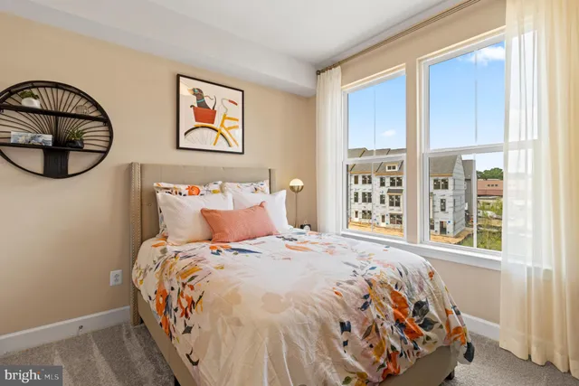 a large bed sitting in a bedroom next to a window