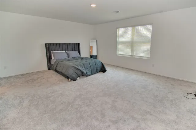 a bedroom with a bed and window
