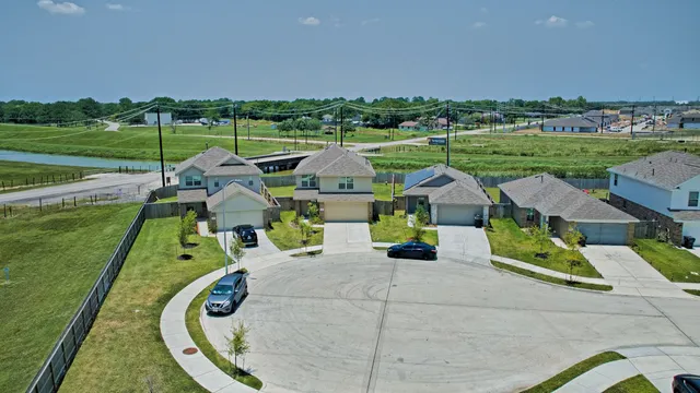 an aerial view of a house with a big yard
