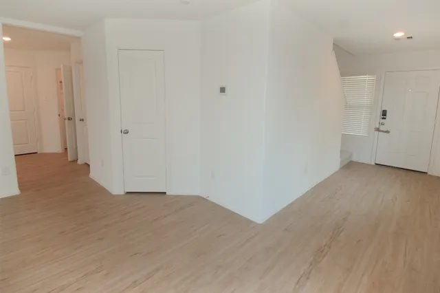 a view of a room with wooden floor