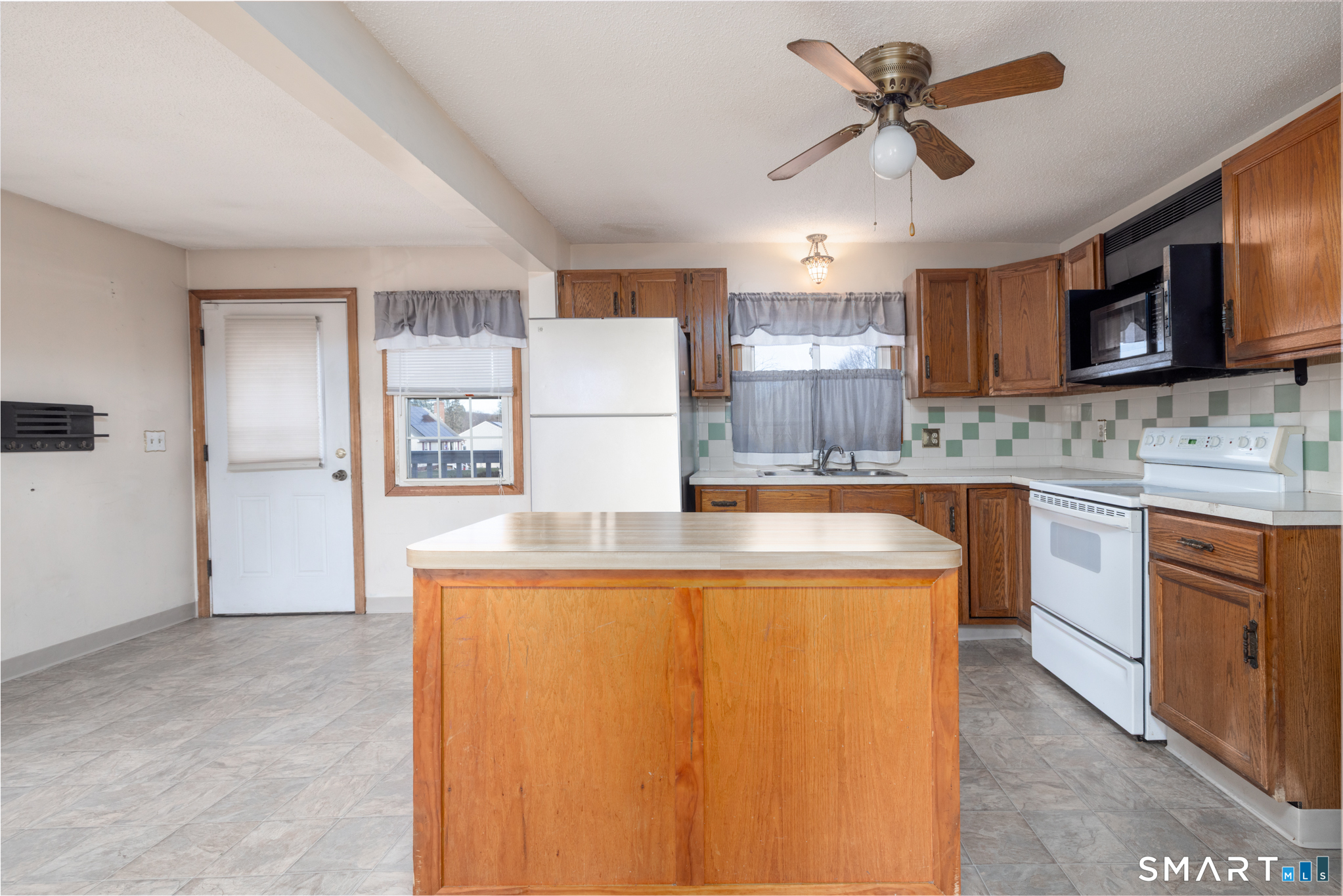 3 Sandra Street Bristol, CT 06010 - Photo 11 of 31 a kitchen with kitchen island a counter top space stainless steel appliances and cabinets