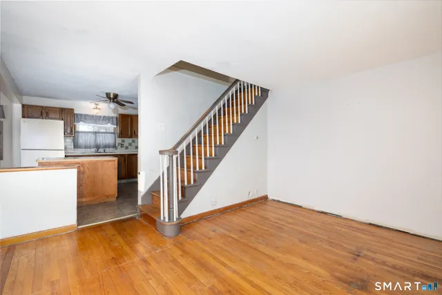 a view of a kitchen with wooden floor and electronic appliances