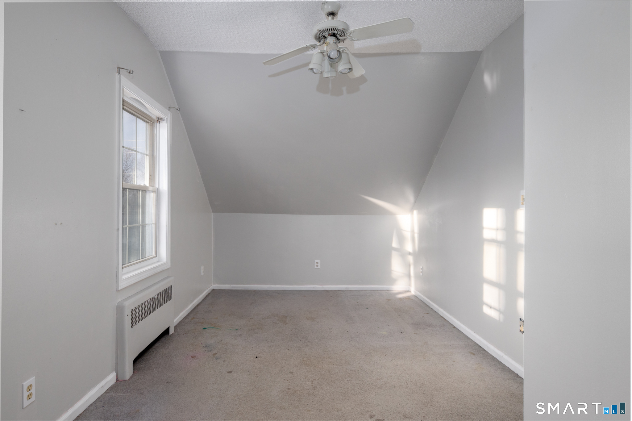 3 Sandra Street Bristol, CT 06010 - Photo 23 of 31 an empty room with windows and chandelier fan