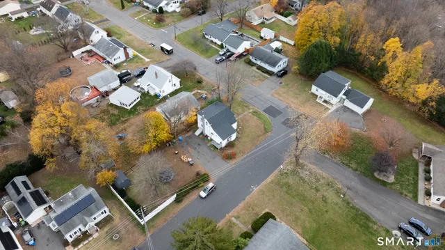 an aerial view of a house with a yard