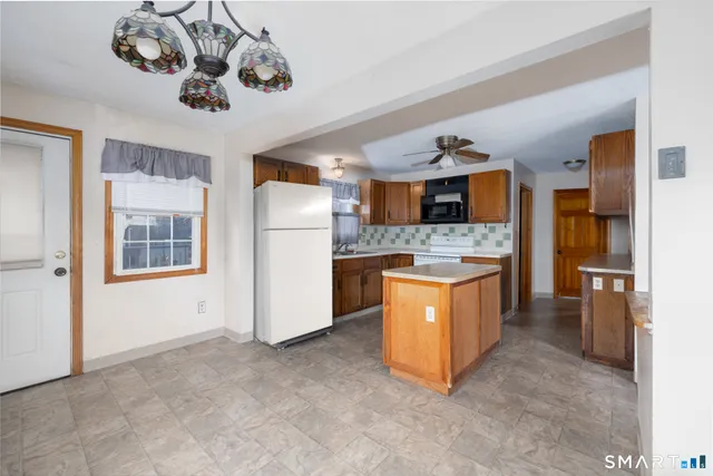 a kitchen with a stove a refrigerator and a sink