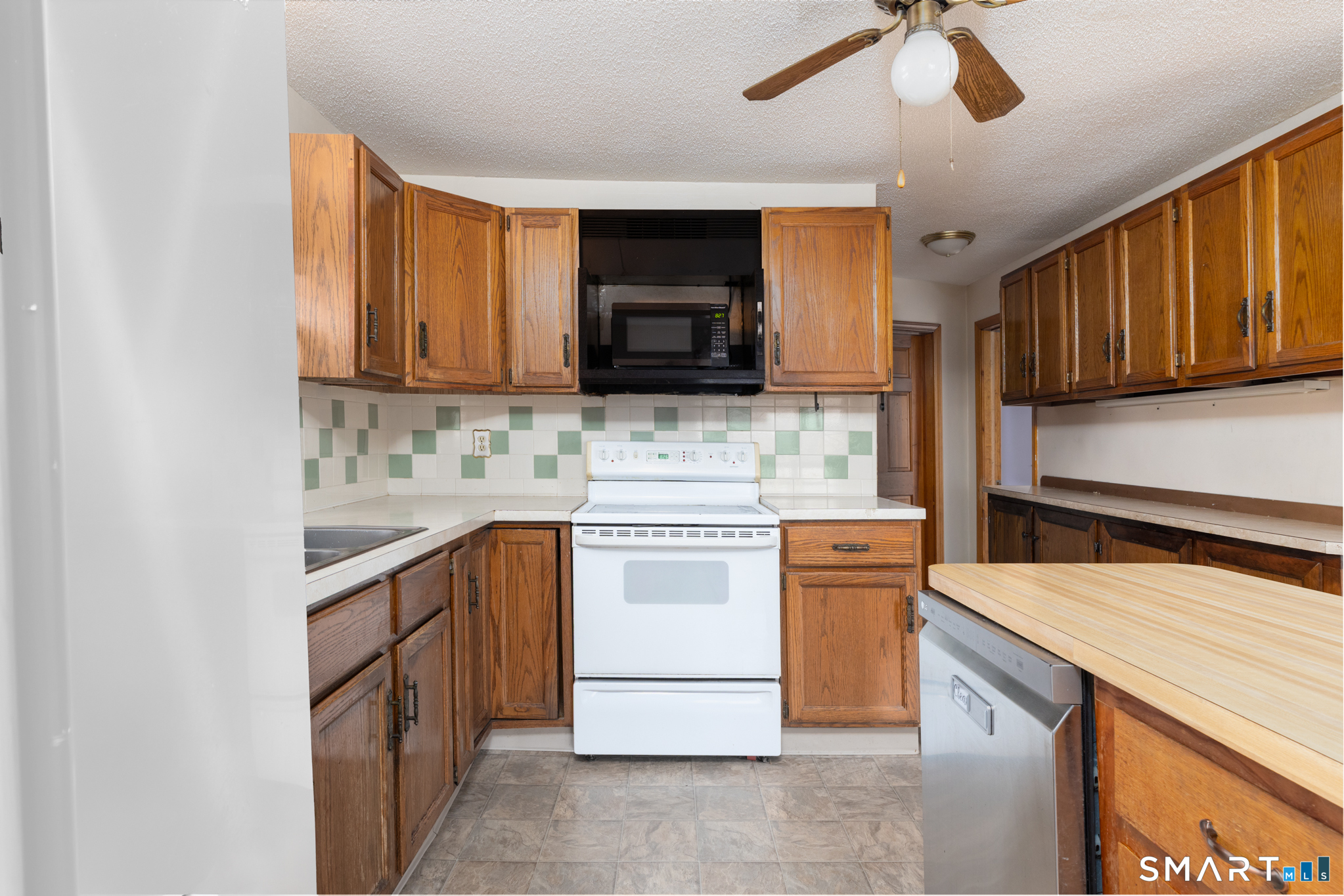 3 Sandra Street Bristol, CT 06010 - Photo 9 of 31 a kitchen with stainless steel appliances granite countertop a stove top oven a sink and a microwave
