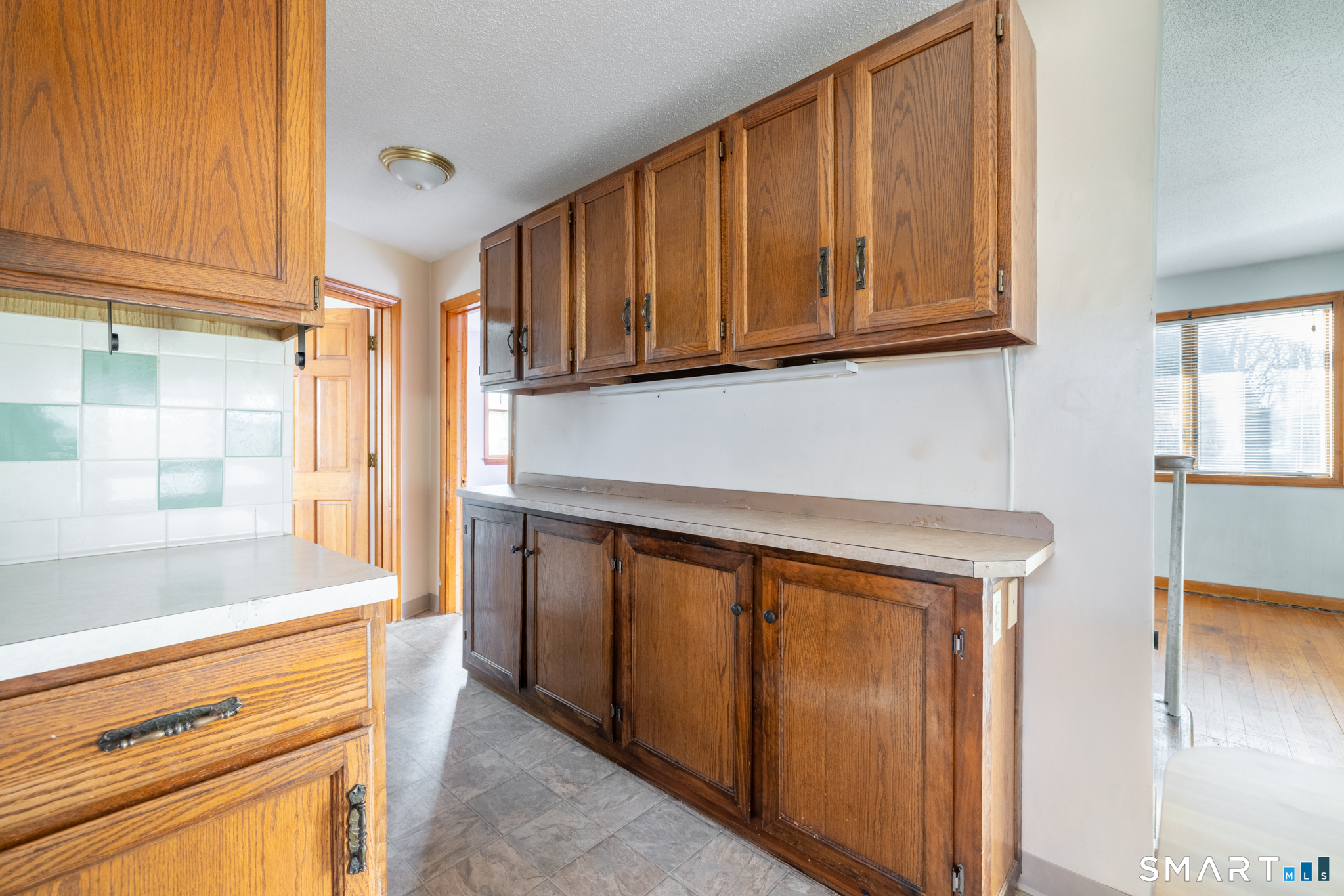 3 Sandra Street Bristol, CT 06010 - Photo 10 of 31 a kitchen with stainless steel appliances granite countertop a refrigerator and cabinets