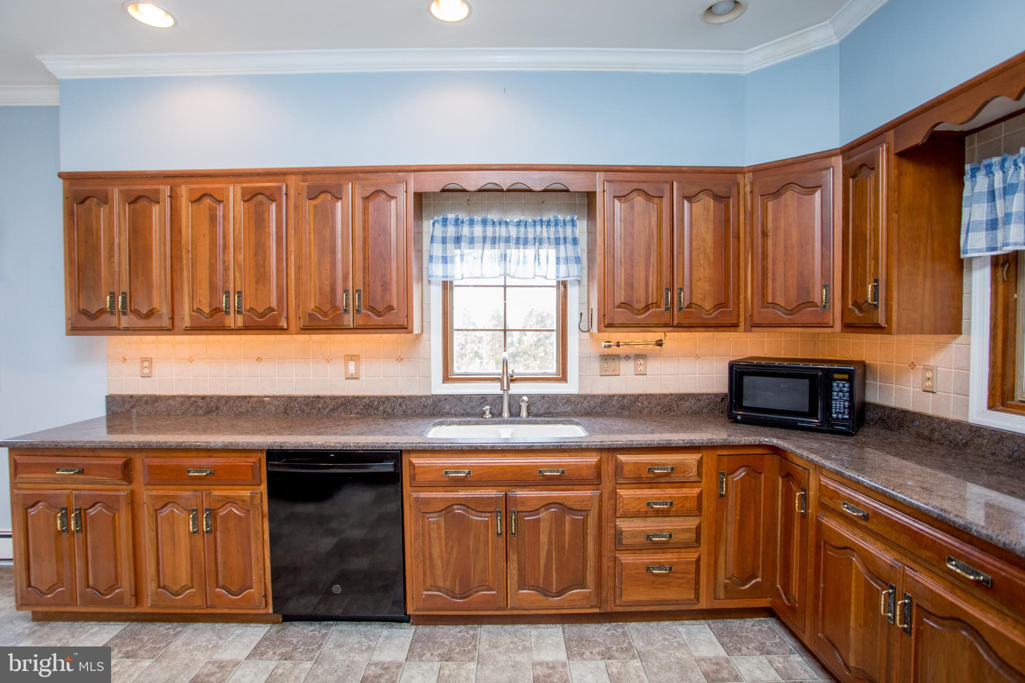 242 South Sugan Road New Hope, PA 18938 - Photo 12 of 35 a kitchen with granite countertop a sink and cabinets