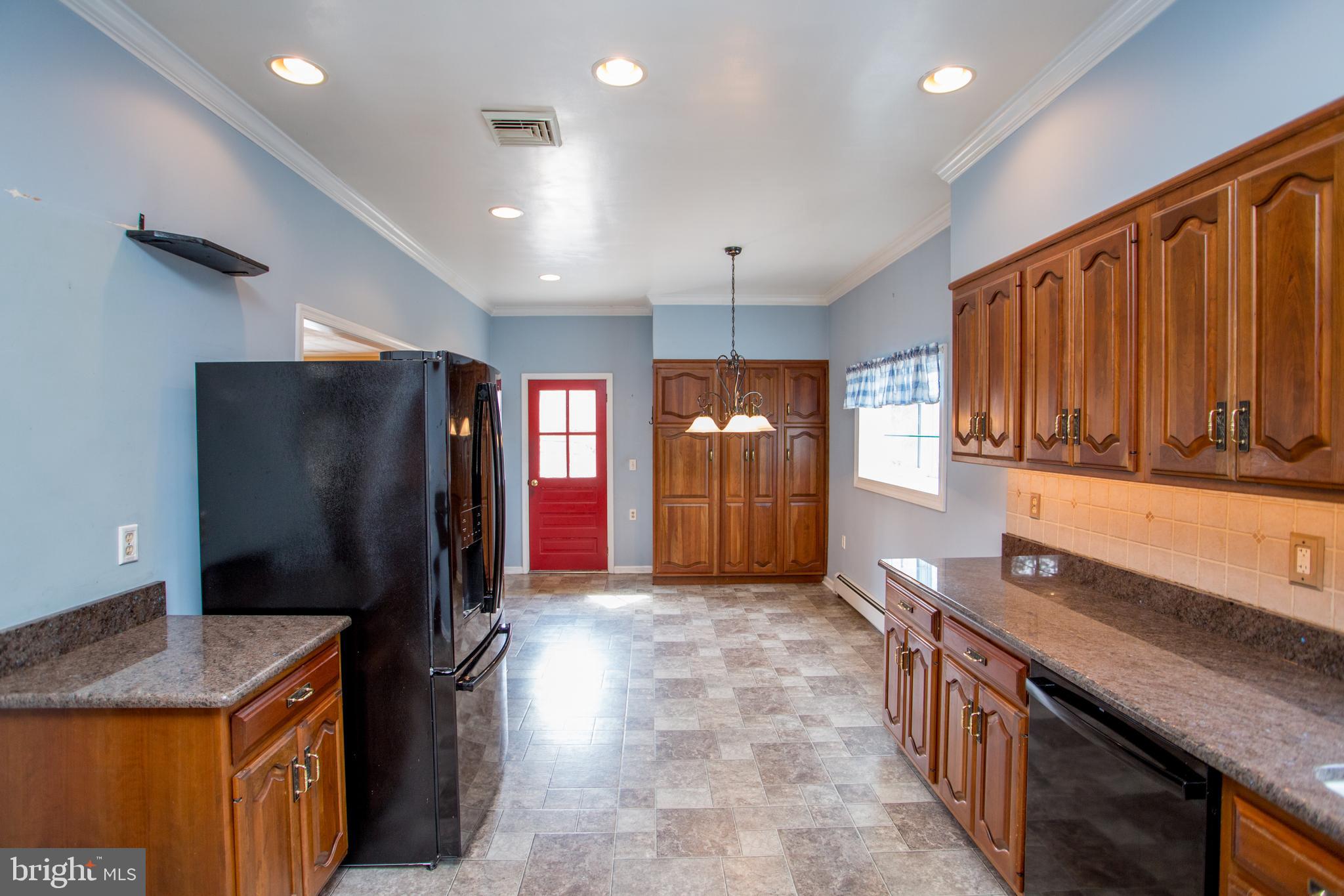 242 South Sugan Road New Hope, PA 18938 - Photo 13 of 35 a kitchen with stainless steel appliances granite countertop a refrigerator a stove and a sink