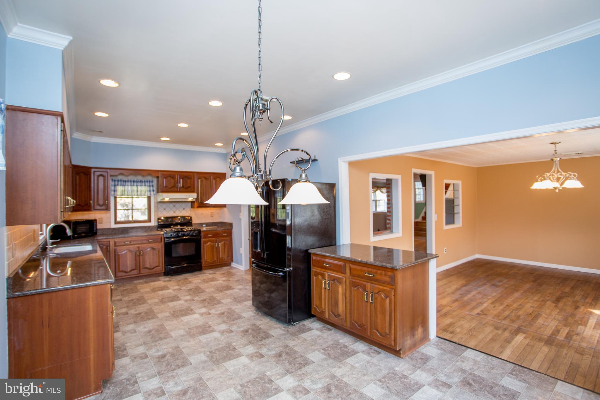242 South Sugan Road New Hope, PA 18938 - Photo 15 of 35 a kitchen with stainless steel appliances granite countertop a sink counter space and wooden floor