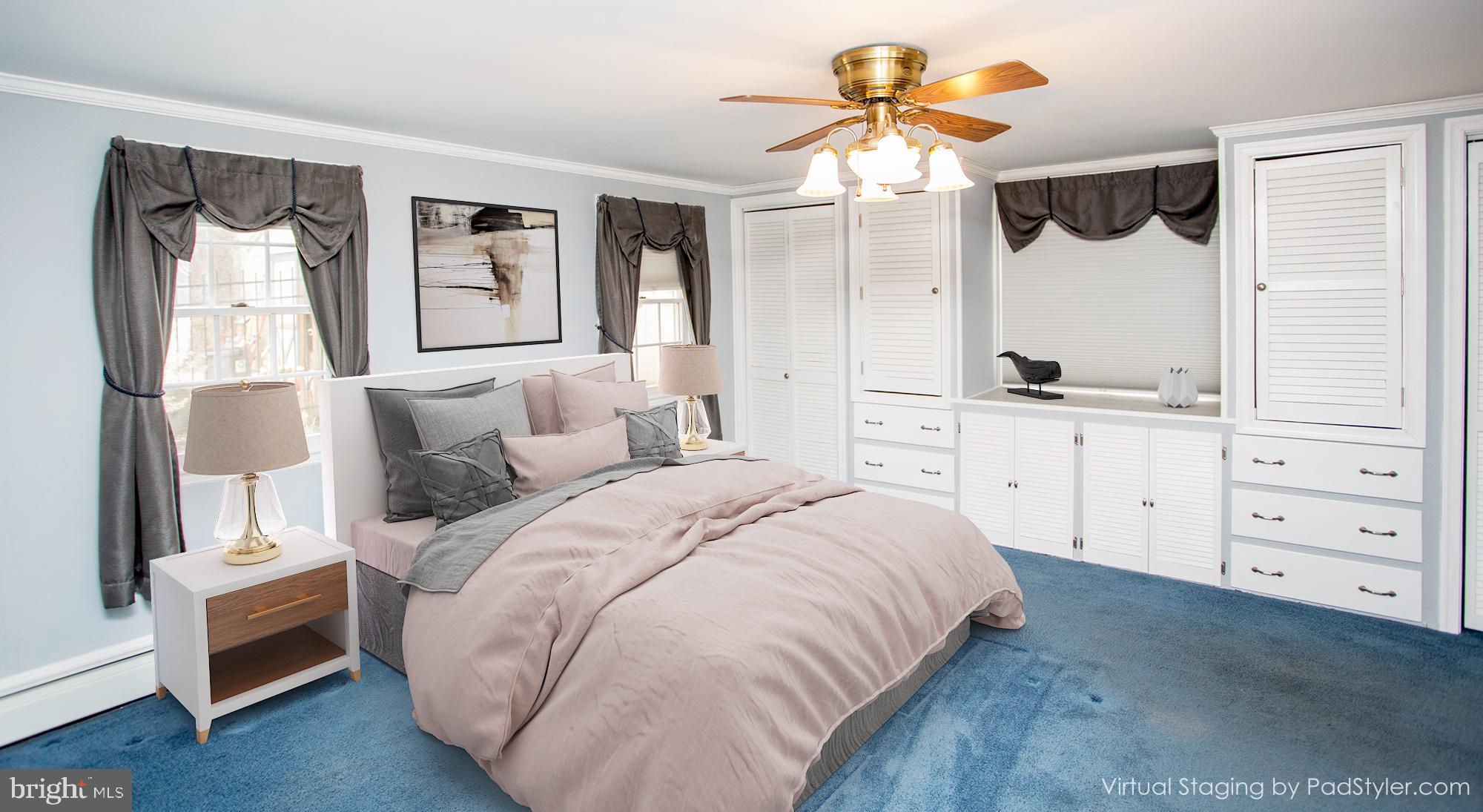 242 South Sugan Road New Hope, PA 18938 - Photo 21 of 35 a spacious bedroom with a bed a window and a chandelier