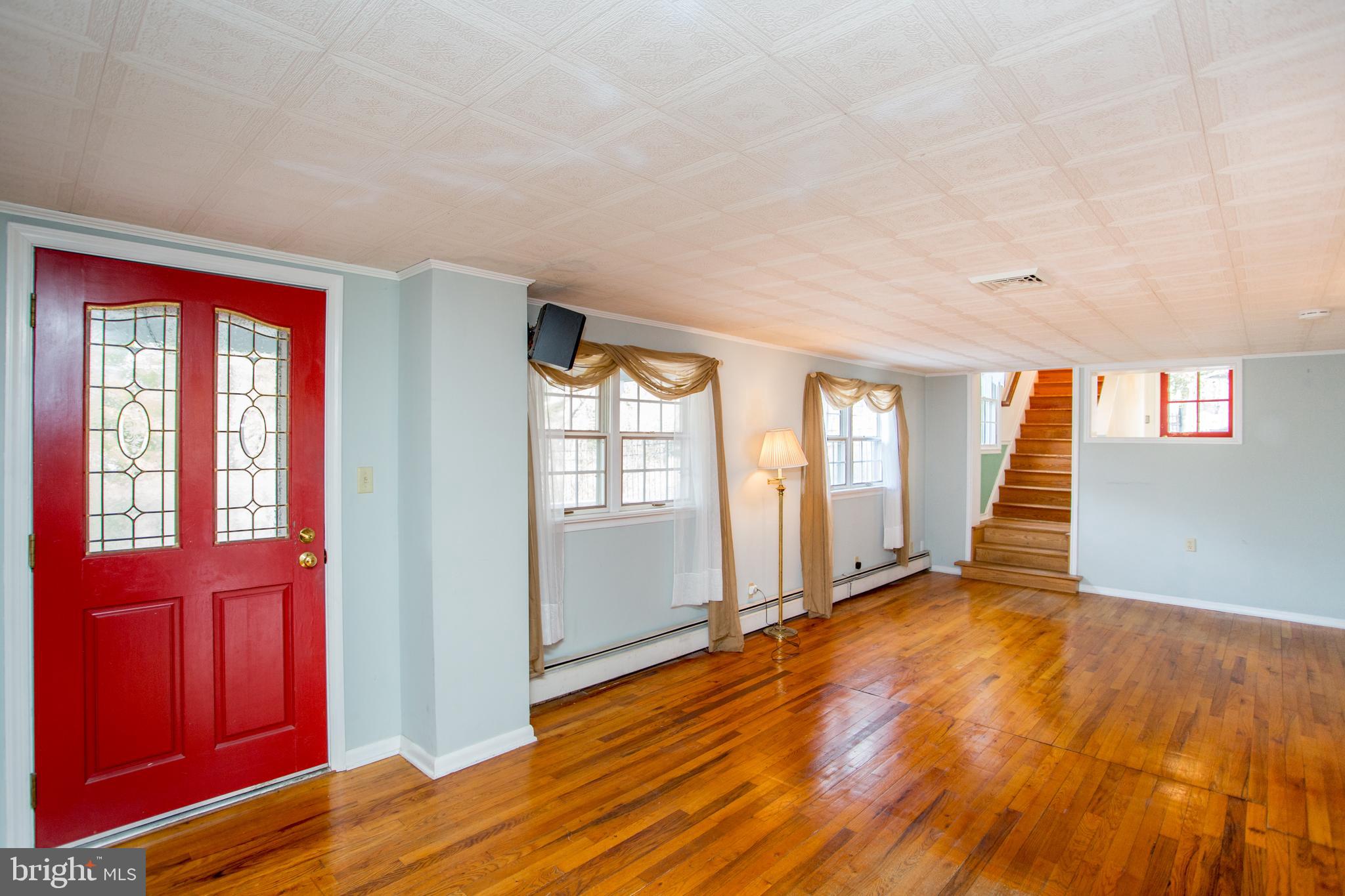 242 South Sugan Road New Hope, PA 18938 - Photo 6 of 35 a view of an empty room with wooden floor and a window