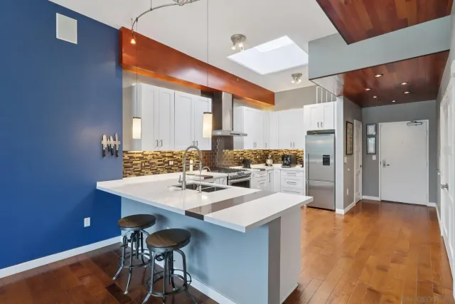 a kitchen with a sink appliances and cabinets