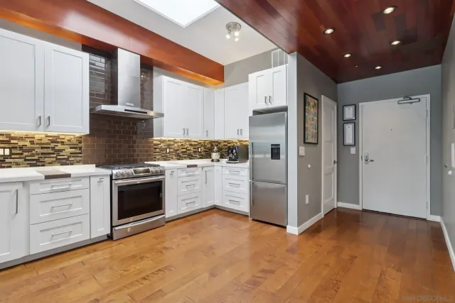 a kitchen with white cabinets and white appliances