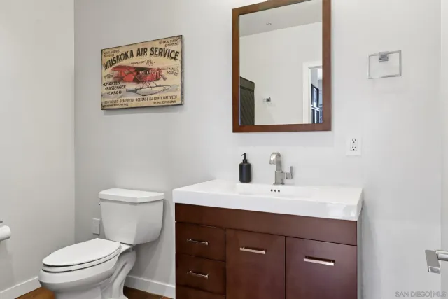 a bathroom with a toilet a sink and mirror