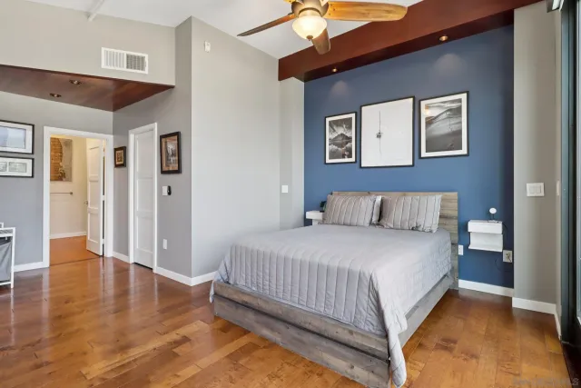 a bedroom with a bed and wooden floor